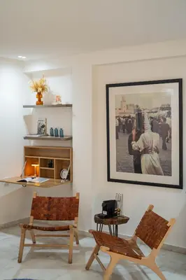 a living room with two chairs and a picture on the wall at NEW ! Unique Equipped Flat in the Heart of Marrakech in Marrakech
