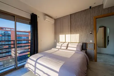 a bedroom with a large bed and a large window at NEW ! Unique Equipped Flat in the Heart of Marrakech in Marrakech