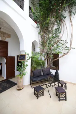 a living room with a couch and a table at Riad Noor Charana in Marrakech