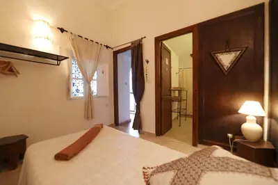 a bedroom with a white bed and a mirror at Riad Noor Charana in Marrakech