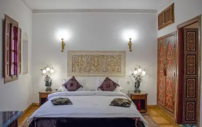 a bedroom with a large bed and two night stands at Riad Esmeralda in Marrakech