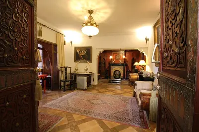a hallway with a living room with a fireplace at Riad Esmeralda in Marrakech