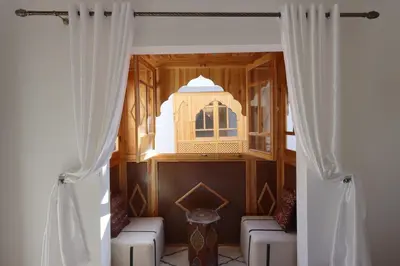 a room with white curtains and a window at Riad Jenan L'mouassine in Marrakech