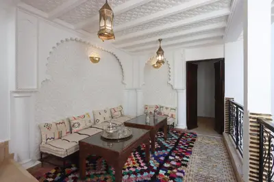 a living room with a couch and a table at Riad Jenan L'mouassine in Marrakech