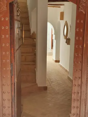 a hallway with stairs in a house at Riad Le Manzil Beldi in Marrakech
