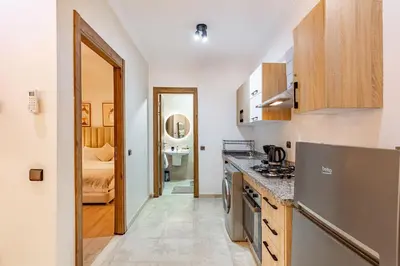 a kitchen with a sink and a counter top at Jolie & Luxueux Appart a Gueliz - 100% Équipé in Marrakech