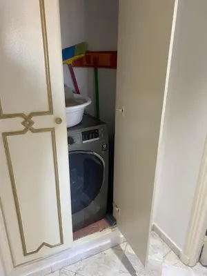 a door open to a laundry room with a washing machine at Appartment le bleu in Marrakech