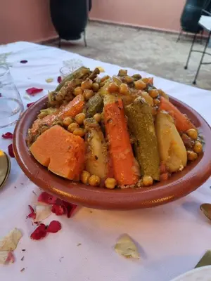 a plate of food with vegetables and beans on a table at Riad Beni Sidel in Marrakech