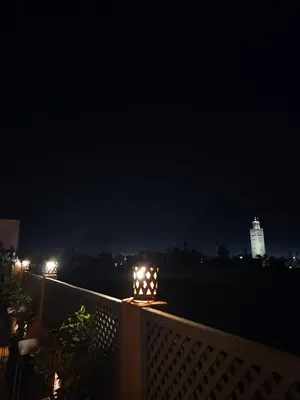 a fence with lights on it at night at Riad Beni Sidel in Marrakech