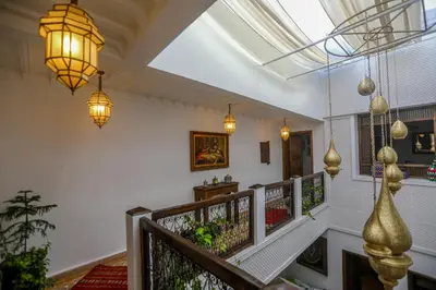 a hallway with a staircase with lights and plants at Riad Beni Sidel in Marrakech