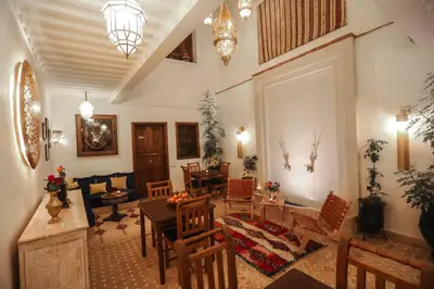 a living room with a table and chairs at Riad Beni Sidel in Marrakech