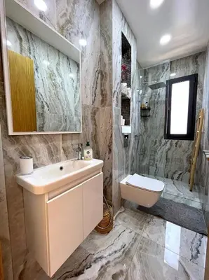 a bathroom with a sink and a toilet and a shower at Belle et spacieuse villa au Golf Amelkis Marrakech in Marrakech