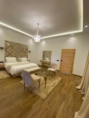 a large bedroom with a bed and a chandelier at Villa 7palms in Marrakech