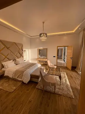 a large bedroom with a large bed and a desk at Villa 7palms in Marrakech