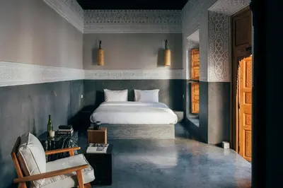 a bedroom with a bed and a chair in it at Riad no37 in Marrakech