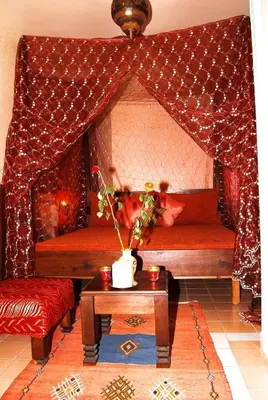 a living room with two beds and a table at Chez Peyo in Marrakech