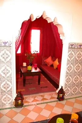 a living room with a red couch and a table at Chez Peyo in Marrakech