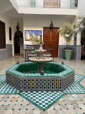 a fountain in the middle of a room at Riad Dar Teranga Hotel & Spa in Marrakech