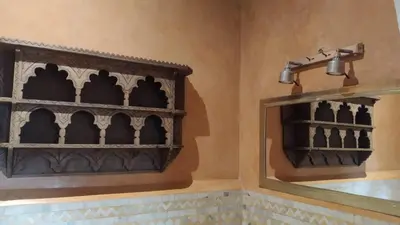 a bathroom with a black shelf and a mirror at Riad Dar Teranga Hotel & Spa in Marrakech