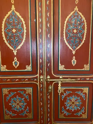 a pair of wooden cabinets with designs on them at Riad Dar Teranga Hotel & Spa in Marrakech