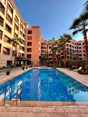 a large swimming pool in front of some buildings at Appartement chambre salon a l'hivernage 9 in Marrakech