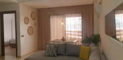 a living room with a couch and a table at Apparemment wafaa in Marrakech