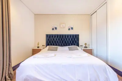 a bedroom with a large bed with a blue headboard at NEW! Luxe et moderne en plein Guéliz, Terrasse in Marrakech
