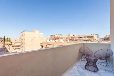 two chairs on a balcony with a view of a city at NEW! Luxe et moderne en plein Guéliz, Terrasse in Marrakech