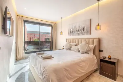 a bedroom with a large bed and a large window at New ! Stunning and Comfortable apartement in Marrakech