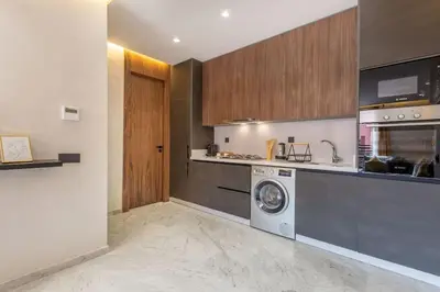 a kitchen with a washer and a washing machine at New ! Stunning and Comfortable apartement in Marrakech