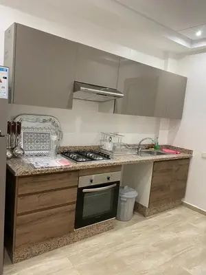 a kitchen with a sink and a stove top oven at Appartement a loué pour les familles in Marrakech