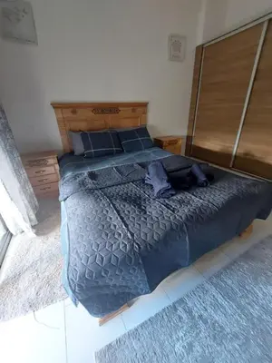 a bedroom with a large bed with a wooden headboard at Morooco Home in Marrakech