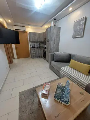 a living room with a couch and a table at Morooco Home in Marrakech