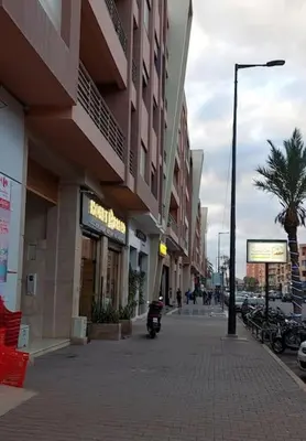 a street with buildings and a motorcycle on a sidewalk at Morooco Home in Marrakech