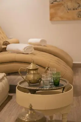 a coffee table with a tea pot and glasses on it at Riad l'Esprit des Patios & Spa in Marrakech