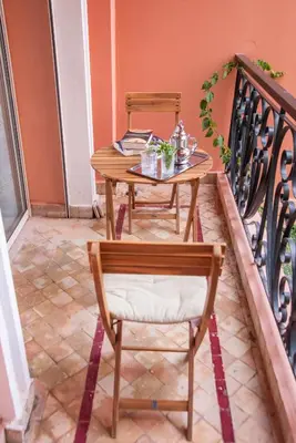 a table and two chairs on a balcony at Beautiful, great equipped 122 m holiday apartment near Majorelle Garden and Gueliz with pool views and a large balcony and terrace in Marrakech