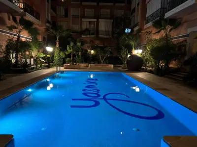 a swimming pool in a hotel at night at Beautiful, great equipped 122 m holiday apartment near Majorelle Garden and Gueliz with pool views and a large balcony and terrace in Marrakech