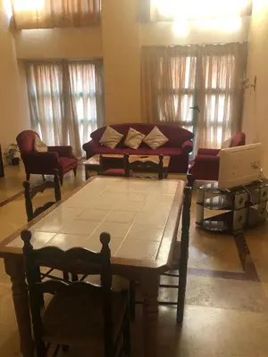 a living room with a couch and a table at Propre appartement à loué pour les familles in Marrakech