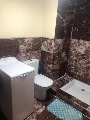 a bathroom with a toilet and a sink and a tub at Propre appartement à loué pour les familles in Marrakech