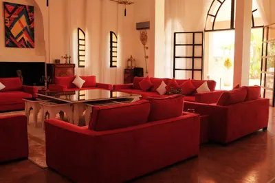 a living room with red couches and a table at Villas Green in Marrakech