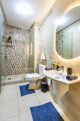 a bathroom with a sink and a toilet and a shower at Magnificent Apartment in Gueliz - 100% Equipped in Marrakech