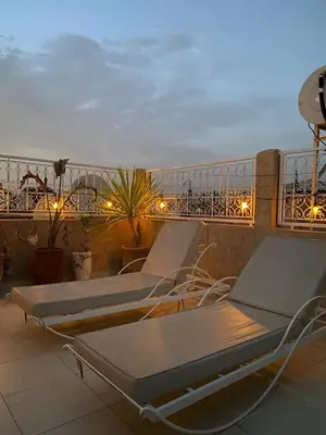 two lounge chairs on a balcony with the ocean at Riad with Outdoor Swimming Pools in Marrakech
