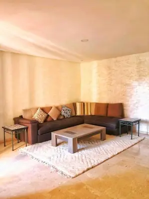 a living room with a couch and a table at Magnifique Duplex En Plein Hivernage à Marrakech in Marrakech