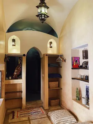 a room with a hallway with a chandelier and shelves at Riad Sidi Radoine in Marrakech