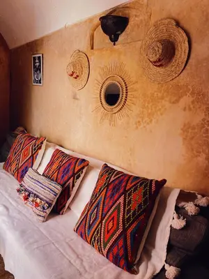 a bedroom with a bed with two pillows on it at Riad Sidi Radoine in Marrakech