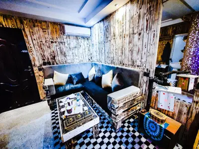 a living room with a blue couch and a table at Appartement funny house a place jamaa el fna de marrakech in Marrakech