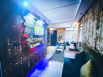 a room with a couch and a tv on a wall at Appartement funny house a place jamaa el fna de marrakech in Marrakech