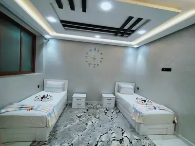 a room with two beds in a room with a ceiling at Appartement de luxe à 7 min de Centre de ville a petit prix pour passer un agréable séjour in Marrakech