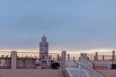 a lighthouse on the beach with the ocean in the background at Paisible riad privatif au cœur de Marrakech in Marrakech