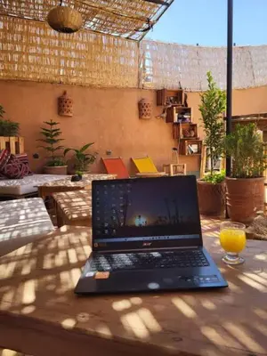 a laptop computer sitting on top of a table at Happy Marrakchy in Marrakech
